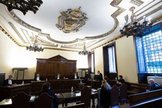 This Oct. 14, 2020, file photo shows the Vatican City State criminal court during the opening of the trial of Father Gabriele Martinelli and Msgr. Enrico Radice. Father Martinelli is accused of repeatedly sexually abusing a younger student at the Vatican&#039;s St. Pius X Pre-Seminary. Msgr. Enrico Radice, former rector of the seminary, has been accused of obstructing the investigation into the younger priest. Defendants in the court are normally seated on the bench at right. 