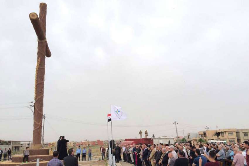 Syrian Catholic Archbishop Youhanna Boutros Moshe of Mosul blesses a newly-erected cross in Bakhdida, Iraq, May 2.