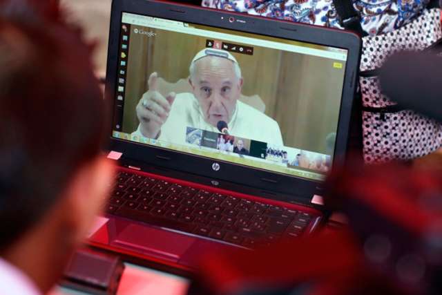 Pope Francis video chats with a Salvadoran student in the gang-infested neighborhood of La Campanera, San Salvador, Sept. 4. The pope said all of society needs to help children and young people who are homeless, exploited, victims of violence or without any prospects.