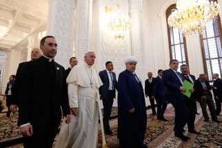 Pope Francis walks with Sheik Allahshukur Pashazade, the region&#039;s chief imam, during a meeting with representatives of other religious communities at the Heydar Aliyev mosque in Baku, Azerbaijan, Oct. 2.