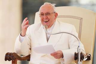  Pope Francis laughs after losing his zucchetto to a gust of window during his general audience in St. Peter&#039;s Square at the Vatican March 21.