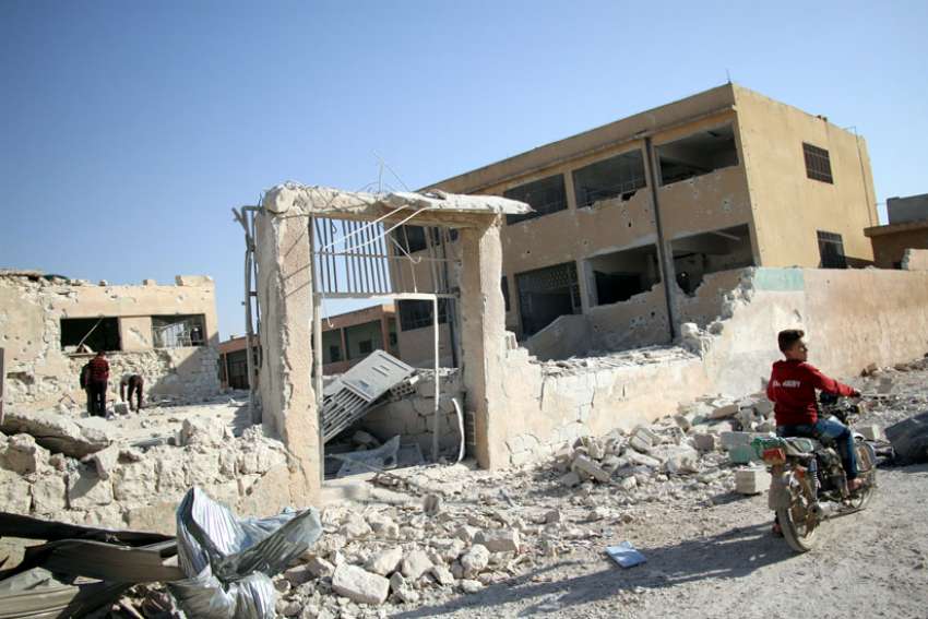Syrians check a school Oct. 27 that was bombed a day earlier in the rebel-held province of Idlib, Syria.