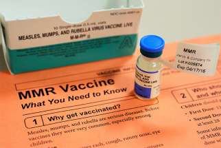A vial of measles, mumps and rubella vaccine and an information sheet is seen at Boston Children&#039;s Hospital Feb. 26, 2015. Catholic parents should vaccinate their children for the good of their children and the community, and they can do so with a &quot;clear conscience&quot; that &quot;the use of such vaccines does not signify some sort of cooperation in voluntary abortion,&quot; said the Pontifical Academy for Life. 