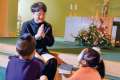 After celebrating Sunday morning Mass at Sacred Heart of Jesus Parish in Korean, Fr. Anselmo Park teaches two children, Aiden Chung and Olivia Yang, about the Catholic faith, just as Park will do after returning to South Korea. 