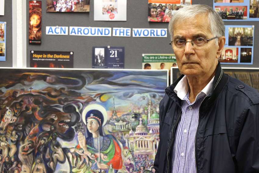 Farid Georges, a Syriac Christian from Homs, Syria, poses for a photo in England June 23. His artwork depicting Syria&#039;s six-year war is being shown in Catholic cathedrals of northwest England and Wales.