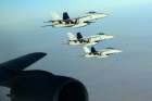 US Navy F-18E Super Hornets make a formation after receiving fuel from a KC-135 Stratotanker over northern Iraq Sept. 23. These aircraft were part of a large coalition strike package that was the first to strike Islamic State targets in Syria. 