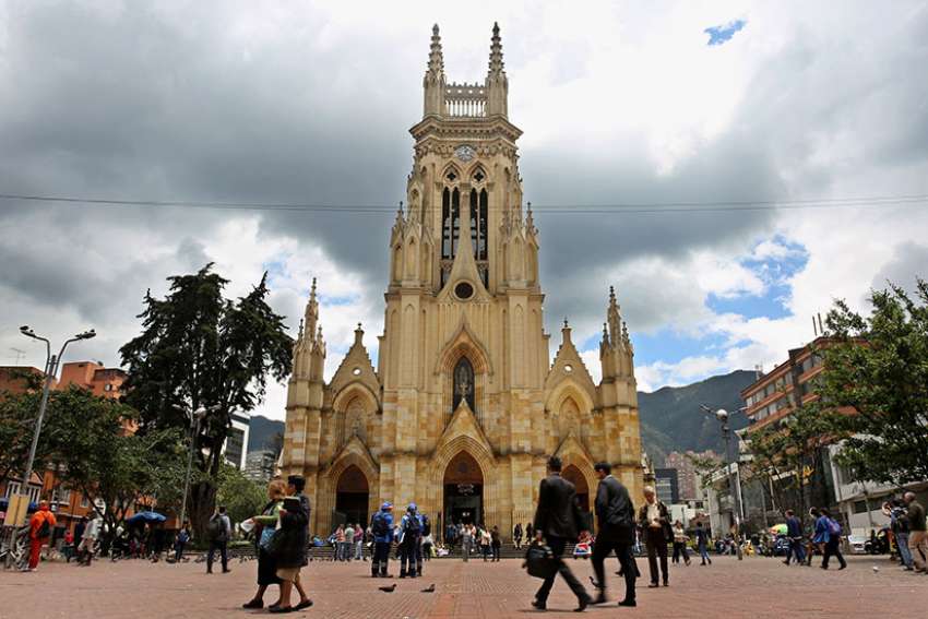 People walk in front of Our Lady of Lourdes Church in Bogota, Colombia, March 1. Vatican spokesman Greg Burke confirmed July 7 that Pope Francis will beatify Bishop Jesus Emilio Jaramillo Monsalve of Arauca and Father Pedro Ramirez Ramos during his September visit to the South American nation.