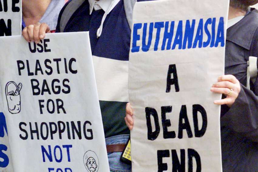 Protesters against euthanasia gather near where assisted-suicide campaigner Dr. Philip Nitschke (not pictured) unveiled his lethal injection &quot;Aussie Bag&quot; in Brisbane, Australia, Aug. 20, 2002. The parliament of New South Wales, Australia&#039;s most populous state, passed a law allowing people to choose assisted dying under certain circumstances May 19, 2022.