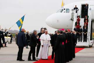 Pope Francis greets people as he arrives at the international airport in Malmo, Sweden, Oct. 31. The pope is making a two-day visit to Sweden to attend events marking the 500th anniversary of the Protestant Reformation.