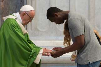 Pope Francis receives the gifts as he celebrates a Mass for migrants in St. Peter&#039;s Basilica at the Vatican July 6. The pontiff celebrated the Mass to commemorate the fifth anniversary of his visit to the southern Mediterranean island of Lampedusa.