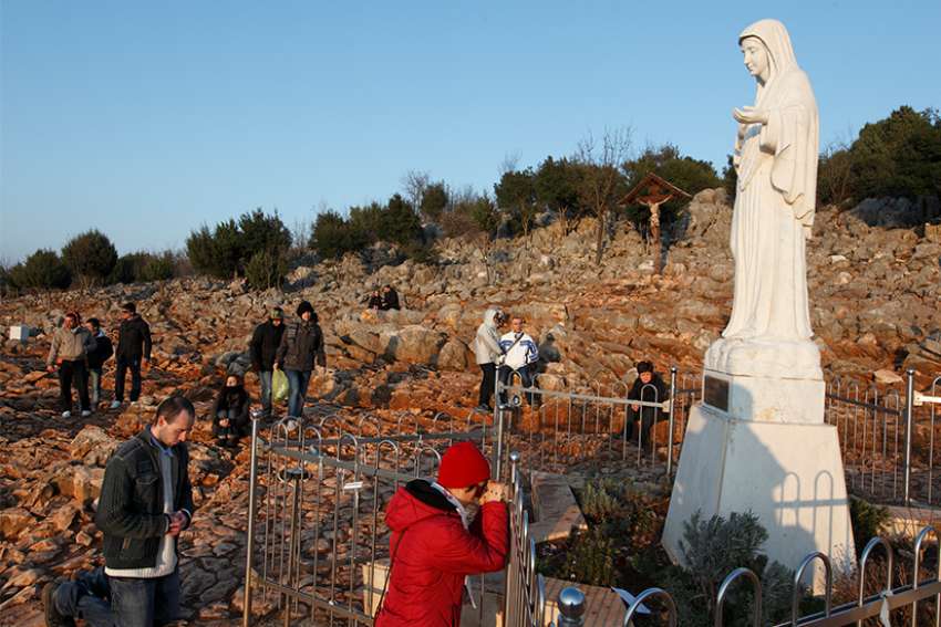 Pilgrims pray in front of a statue of Mary in 2011 on Apparition Hill in Medjugorje, Bosnia-Herzegovina. The Pope appointed Archbishop Henryk Hoser, the retired archbishop of Warsaw-Praga, Poland, to be apostolic visitor to Medjugorje.