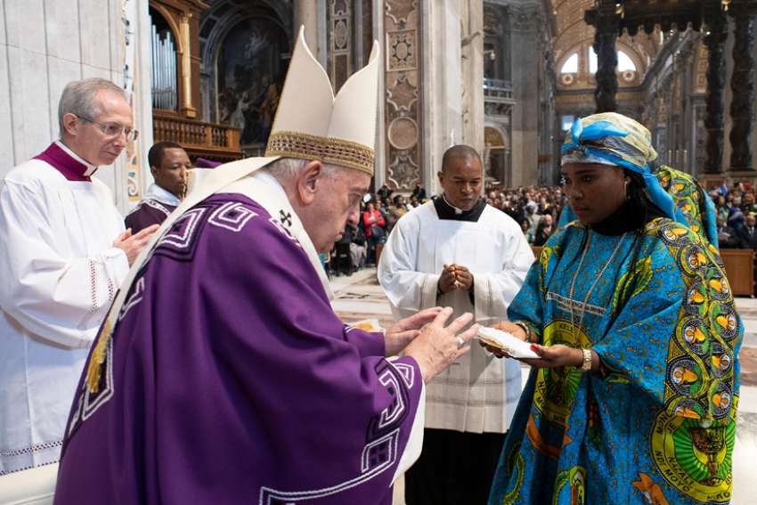 Pope Francis accepts offertory gifts as he celebrates a Mass for the Congolese Catholic community in Rome in St. Peter&#039;s Basilica at the Vatican Dec. 1, 2019. The Mass included elements of Congolese culture.