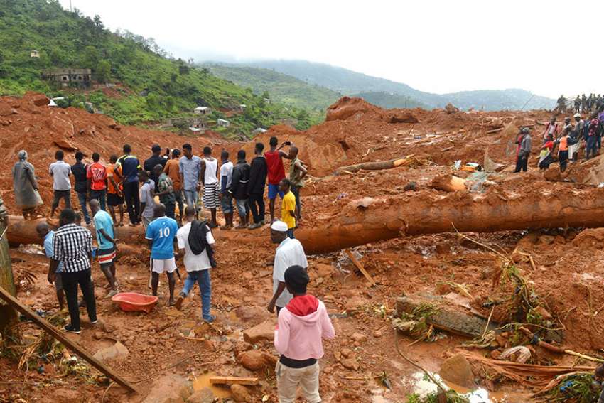 Residents and rescue workers search for survivors after a mudslide in Regent, Sierra Leone Aug. 14.