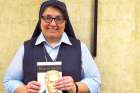Film critic Sr. Rose Pacatte with her new book on Martin Sheen.