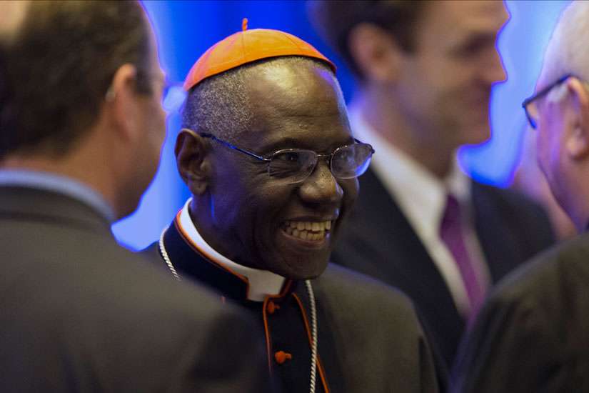 Guinean Cardinal Robert Sarah, prefect of the Congregation for Divine Worship, smiles as he talks with guests at the National Catholic Prayer Breakfast May 17 in Washington.