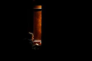A woman goes to confession in darkness at the start of the Easter Vigil led by Pope Francis in St. Peter&#039;s Basilica at the Vatican Mar. 2016.