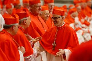 New Canadian Cardinal Michael Czerny greets French Cardinal Dominique Mamberti during a consistory led by Pope Francis for the creation of 13 new cardinals in St. Peter&#039;s Basilica at the Vatican Oct. 5, 2019.