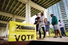 People line up outside a Toronto polling station to vote in the federal election in Toronto Sept. 20.