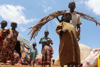 Internally displaced Somali people are seen outside their shelter after fleeing from drought-stricken regions at a makeshift camp in Baidoa, west of Somalia&#039;s capital of Mogadishu, on March 26, 2017.