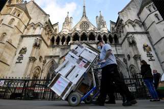  Officials deliver legal documents to the High Court in London Nov. 2, 2020. Bishop Philip Egan of Portsmouth and Catholic doctors welcomed the court ruling stopping children from accessing sex-change therapies.