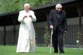 Retired Pope Benedict XVI is seen in a file photo strolling in a garden in Bressanone, Italy, with his brother, Msgr. Georg Ratzinger. The retired pope has declined the inheritance of his brother Georg -- who died July 1, 2020 -- so the estate goes to the Holy See.