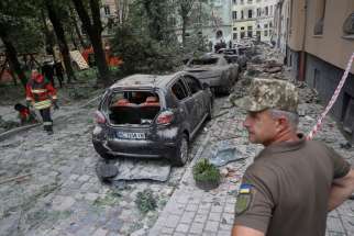 Emergency personnel examine the area around a residential building that was hit by a Russian missile strike in Lviv, Ukraine, July 6, 2023. The missile attack killed at least four people, injured 37 others and destroyed hundreds of homes, apartments and other buildings and struck within some 600 feet of Ukrainian Catholic University, which sustained minor damage to four of its campus buildings. No one on campus was injured, the school said in a statement.