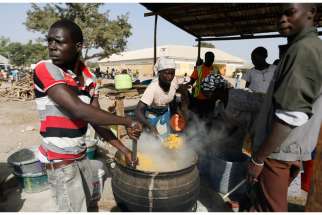 People fleeing Boko Haram violence in the northeast region of Nigeria cook food at a camp for internally displaced people in Yola Jan. 13.
