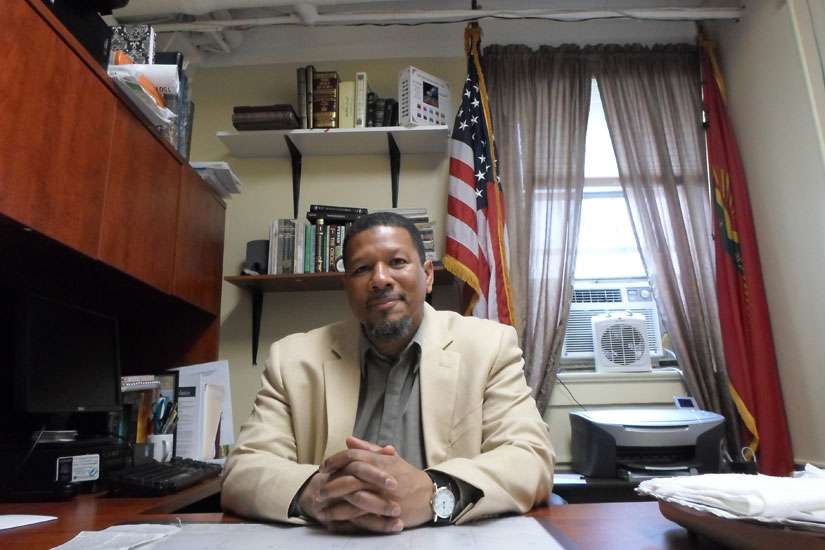 Imam Talib Shareef sits at his desk Nov. 28 at the Nation&#039;s Mosque in Washington, an historically African-American Muslim place of worship. Imam Shareef says attacks carried out by Islamic extremists pose a challenge to all people of faith.