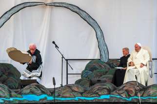 Pope Francis watches as a musician performs during a meeting with young people and elders outside the primary school in Iqaluit in the Canadian territory of Nunavut July 29, 2022.