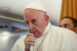 Pope Francis answers questions from journalists aboard his flight from Malmo, Sweden, to Rome Nov. 1. 