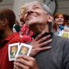 A woman holding holy cards reacts after the election of a new pope outside the Metropolitan Cathedral in Buenos Aires, Argentina, March 13. The world&#039;s cardinals, meeting in conclave at the Vatican, elected as pope Cardinal Jorge Mario Bergoglio of Buen os Aires, who took the name Francis. The 76-year-old Jesuit is the first Latin American pope.