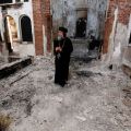 A Coptic Orthodox bishop surveys a damaged church in late August in Minya, Egypt. Concelebrating Mass with the leader of Egypt&#039;s Coptic Catholics, Pope Francis prayed for the safety and religious liberty of Christians in the Middle East.