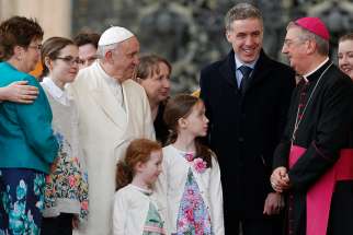 Pope Francis talks with Archbishop Diarmuid Martin of Dublin as he meets an Irish delegation of families during his general audience in St. Peter&#039;s Square at the Vatican March 21. 