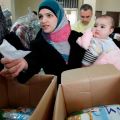 Syrian refugees receive humanitarian aid from an Islamic organization in Tripoli, Lebanon, March 6. As temperatures drop to near freezing in Lebanon, Caritas is working to find shelter for Syrian refugees, mostly women and children.