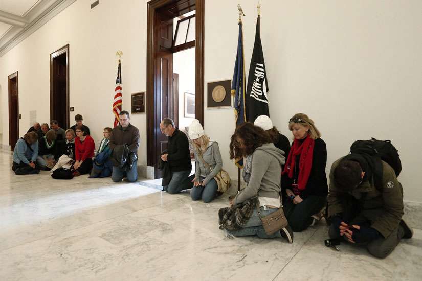 Pro-life supporters pray in the hallway outside U.S. Senate Majority Leader Mitch McConnell&#039;s legislative office on Capitol Hill in Washington Jan. 22. Later that day tens of thousands planned to participate in this year&#039;s March for Life on the 42nd anni versary of the Supreme Court&#039;s 1973 Roe v. Wade decision that legalized abortion virutally on demand. 