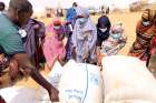 People receive bags of relief grains at a camp for the internally displaced people in Adadle, Ethiopia.