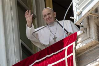 Pope Francis greets the crowd as he leads the Angelus from the window of his studio overlooking St. Peter&#039;s Square at the Vatican in this file photo. On July 5, 2020, the pope backed a U.N. resolution calling for a global cease-fire.
