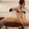 Cinzia Oliva, a textile restorer from Turin, Italy, who specializes in mummy wrappings, puts the finishing touches on restoring the mummy Ny-Maat-Re in the Vatican Museums&#039; collections in this undated photo. Experts have just concluded a two-year compreh ensive study on the seven adult mummies in the Vatican Museums.