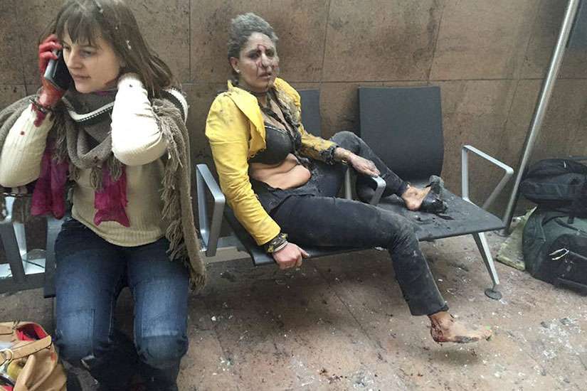 Injured people are seen at the scene of explosions at Zaventem airport near Brussels March 22. 