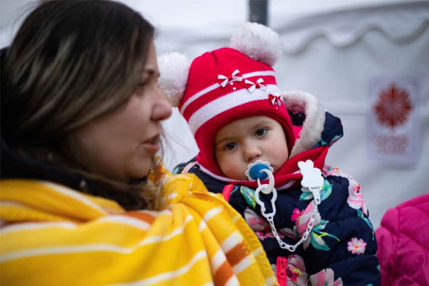 Yulia Tankano is pictured with her daughter, Victoria, at a &quot;refugee hub&quot; at a former supermarket in Przemysl, Poland, near the Urkainian border, March 3, 2022. Since Russia&#039;s invasion began Feb. 24 more than 1.5 million refugees have fled Ukraine, the U.N. refugee agency said.