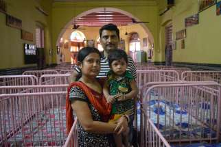 Anirban Mukherjee and his wife, Sampa, pose May 2 with their 17-month-old son Anirban at Shishu Bhavan, the Missionaries of Charity children&#039;s home in Kolkata, India. The parents adopted Anirban from the home in April 2015 and call him &quot;the gift from the saint of Kolkata, Mother Teresa.&quot; 