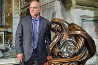 Canadian sculptor Timothy Schmalz poses before speaking to reporters in Rome May 27, 2022, to present the installation of his latest piece, &quot;Life Monument,&quot; a bronze and steel sculpture of Mary and the unborn Jesus in her womb. The 8-foot tall sculpture is permanently installed in the center of Rome at the Church of San Marcello al Corso. A much larger replica will be installed in Washington at an unspecified date after it completes a small tour of the United States.