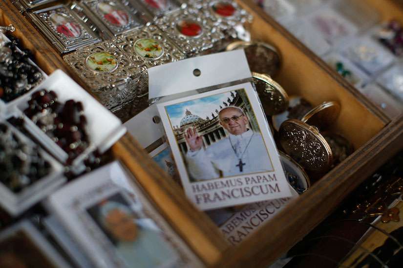 A rosary package with the image of Pope Francis is displayed in a tourist shop outside the Vatican in Rome. 