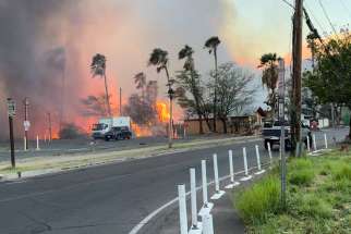 Smoke and flames rise in Lahaina, Hawaii, on the island of Maui Aug. 8, 2023 in this still image from video obtained from social media.