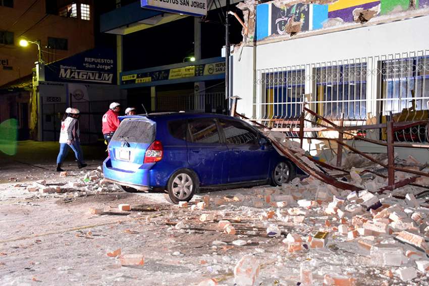 Rescue personnel enter a damaged building June 14 after a magnitude-6.9 earthquake in Quetzaltenango, Guatemala. The earthquake, near the border with Mexico, caused moderate damage to homes, triggered some landslides across highways and injured at least one person, officials said.