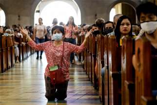 A woman prays during Ash Wednesday Mass at the National Shrine of Our Mother of Perpetual Help in Manila, Philippines, Feb. 26, 2020.