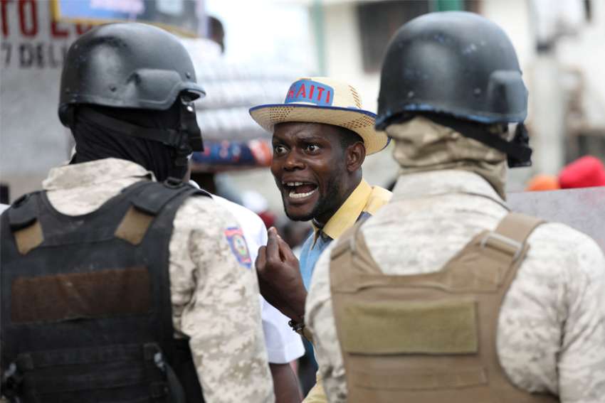 A demonstrator shouts at police during protests demanding that the government of Haitian Prime Minister Ariel Henry do more to address gang violence, including constant kidnappings, in Port-au-Prince March 29, 2022.