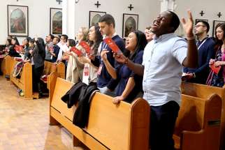 Renew Toronto participants sing during praise and worship before Holy Adoration at St. Basil’s Parish at University of St. Michael’s College.