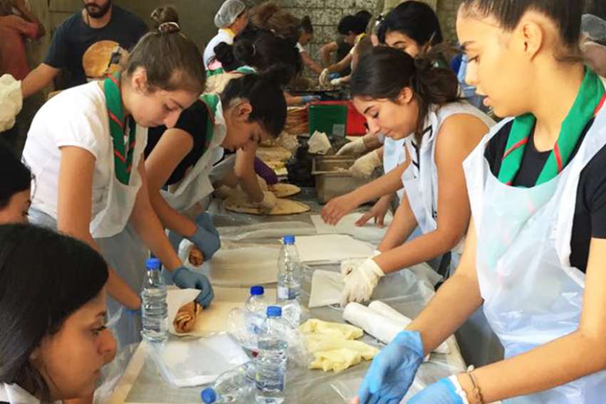 Volunteers prepare some 5,000 sandwiches Aug. 22 for the Lebanese army, which is waging an offensive against an Islamic State enclave.