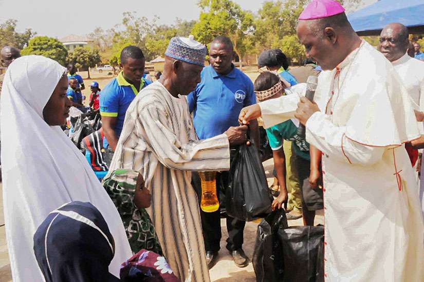 Archbishop Ignatius Kaigama presents relief material to internally displaced persons in Jos, Nigeria, Jan. 20. Many now flee to neighboring Cameroon to escape Boko Haram attacks.